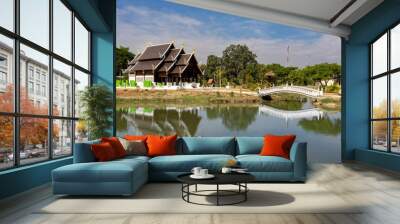 Ancient Thai temple with hip roof Located on the water's edge The building reflects beautifully on the water surface. This architecture represents Thai culture. Wall mural