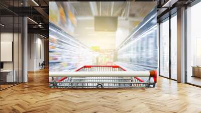 Supermarket aisle with empty red shopping cart Wall mural