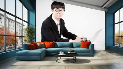 Asian business man using laptop computer isolated on white backg Wall mural