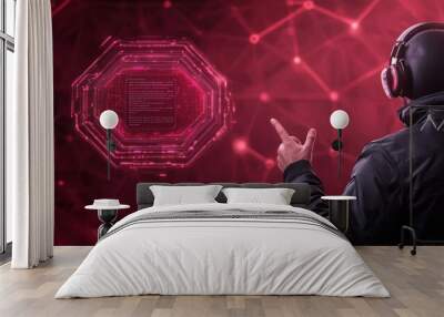 Man in headphones interacting with holographic interface, red futuristic technology background with hexagonal pattern. Wall mural