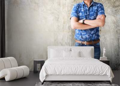 closeup men casual outfits denims standing and cross one's arm. concrete background with space for t Wall mural