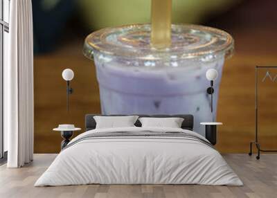 Iced milk bubble tea in plastic glass on wooden saucer. Wall mural