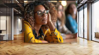 As colleagues discuss, a businesswoman appears asleep, a visual reminder of the need for work-life balance and strategies to combat exhaustion in professional settings. Wall mural