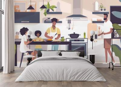 Family cooking a healthy dinner together in a modern kitchen Wall mural