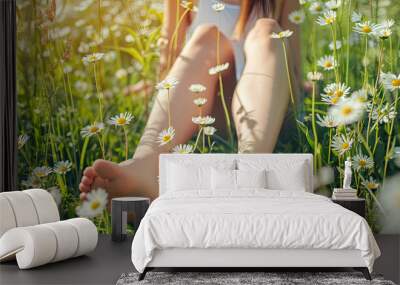 Legs of relaxing girl lying on the spring blooming meadow. Wall mural