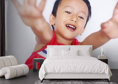 Cute asian child positive and real smile over white background Wall mural