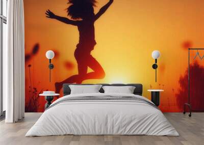 A silhouette of a child playing or jumping, capturing a sense of joy and freedom. Wall mural