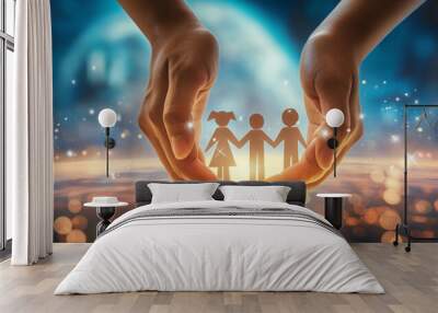 A concept image of protection, security, and care showing hands cradling a paper cutout of a family against a bokeh background Wall mural