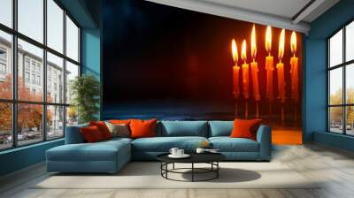 A group of candles burn brightly in the darkness, with a focus on the flames, invoking feelings of warmth, peace, and enlightenment. Wall mural