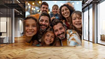 A smiling family with kids taking a joyful selfie together during an outdoor gathering Wall mural