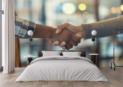 Close-up image of two individuals engaging in a handshake, symbolizing agreement and partnership Wall mural