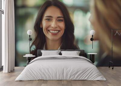 Confident young businesswoman smiles warmly in a modern office environment Wall mural