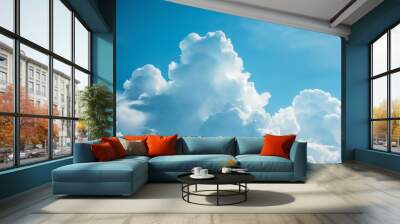 Fluffy cumulus clouds creating a dramatic contrast against the blue sky Wall mural