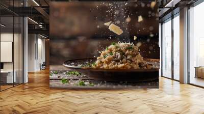 Gourmet mushroom risotto dish with parmesan cheese flakes falling over it in a rustic setting Wall mural