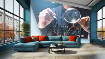 Businessman using magnifying glass to Data analysis Business finance and investment, graph growth chart, stock market report and forex, business growth, work from home or small business Wall mural