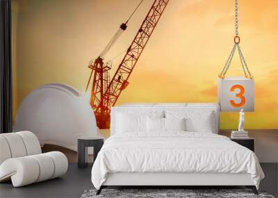 engineer working table and silhouette of a crane construction and golden sky for preparation of welcome 2023 new year party and change new business.	 Wall mural