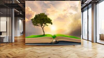 lonely big tree growing up on ancient books like a painting in literature Wall mural