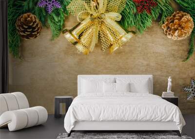 Christmas fir tree with cones and golden bell on a wooden backgr Wall mural