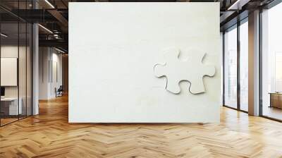 white jigsaw/puzzle whit one gap, over black wooden table background, symbol of problem solving Wall mural