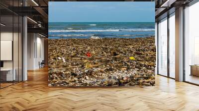 The dirty sea is full of rubbish. Wall mural