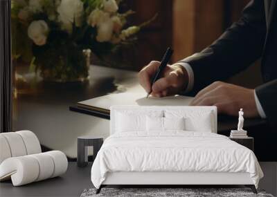 Close-up of a guest signing a reception book in natural light Wall mural