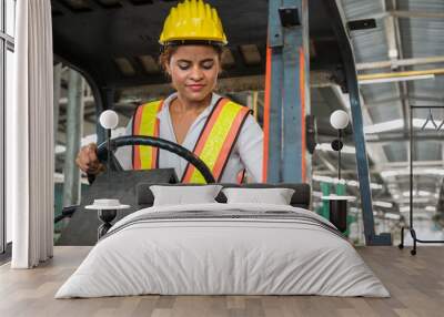 Female industrial worker working and checking machine in a large industrial factory with many equipment. Wall mural