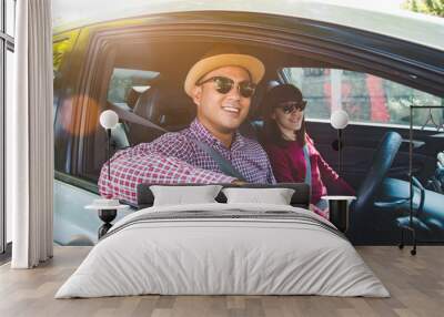 Happy moment couple asian man and woman sitting in car. Enjoying travel concept. Wall mural