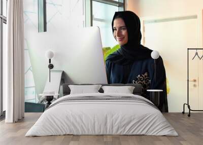 Beautiful Arab Middle Eastern woman on Abaya and Hijab ideal for modern business concept Wall mural