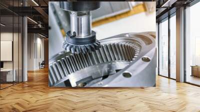 A modern CNC milling machine makes a large gear wheel. Wall mural