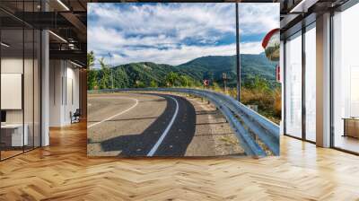 Road to the mountains. Steep and dangerous road turn. Wall mural