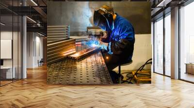 Working welder welds parts factory Wall mural