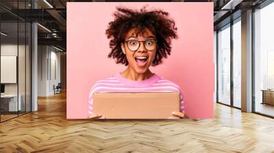 Excited Woman Opening Cardboard Box.. Wall mural