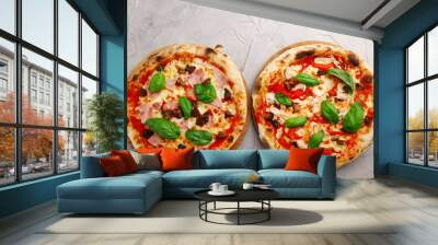 set of two pizza on light concrete or stone table top view. pizza with mushrooms and chicken or hum Wall mural