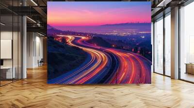 Elevated view of a highway network at twilight, with the glow of city lights and vehicle trails Wall mural