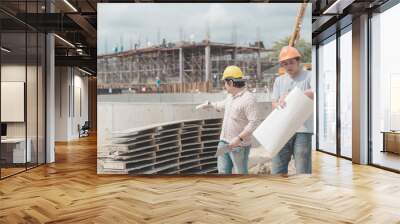 Two young man architect on a building construction site Wall mural