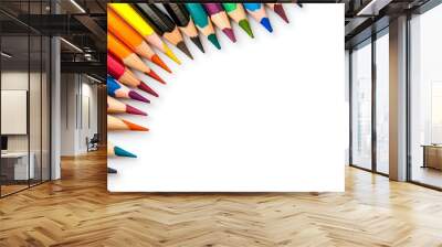 A collection of colorful pencils arranged in a semi-circle shape on a white background, creating a border around a blank space for copy. Wall mural