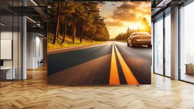 car on asphalt road in countryside at sunset Wall mural