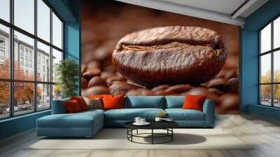 Close-up of a single coffee bean resting on a bed of roasted coffee beans. Wall mural