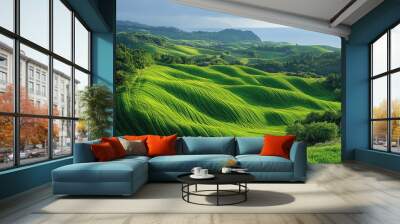 Rolling green hills with a coastal view under a bright blue sky with puffy white clouds. Wall mural