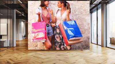 Image of two happy girls with shopping bags Wall mural