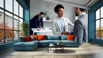 Smiling businessman and businesswoman handshake in office on a meeting Wall mural