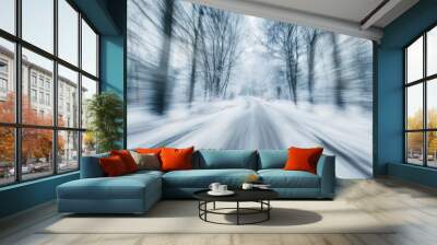 A blurred winter road surrounded by snow-covered trees, evoking a sense of motion and tranquility. Wall mural