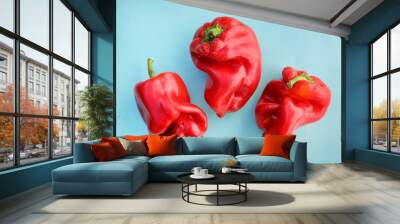 Red sweet pepper . ugly vegetables, three peppers on a blue background. Wall mural