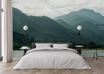 River calm water surface Amazing large green mountains. Nature beauty energy harmonization of soul Wall mural