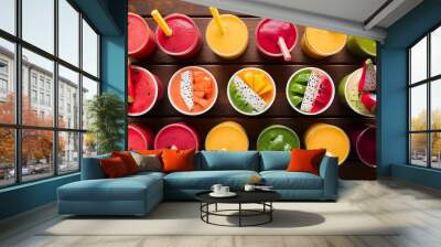 Rainbow from smoothies watermelon papaya mango spinach and dragon fruit smoothies juices beverages drinks variety with fresh fruits on a wooden table Wall mural