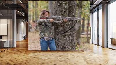 Woman hunting and aiming a shotgun Wall mural