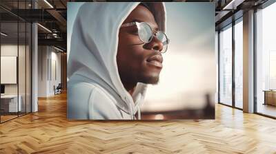 Black man with white hood and glasses looking away. Casual sport dressed African guy posing. Generate ai Wall mural