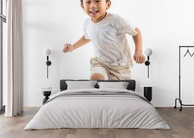 Full length portrait of a happy asian boy running and smiling, isolated on white background Wall mural