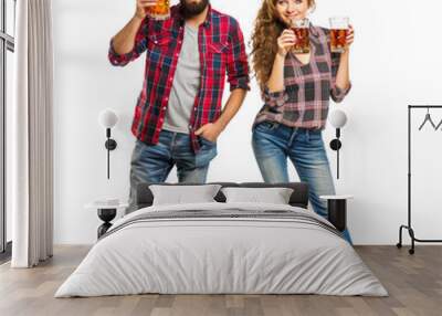 Young man and woman in casual attire smiling and toasting with beer mugs on transparent background Wall mural