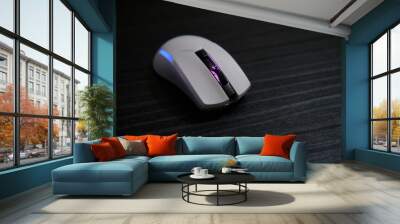 White RGB gaming mouse on a black desk . Wall mural